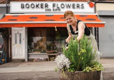 Booker Flowers and gifts charity work with planting community barrel planters